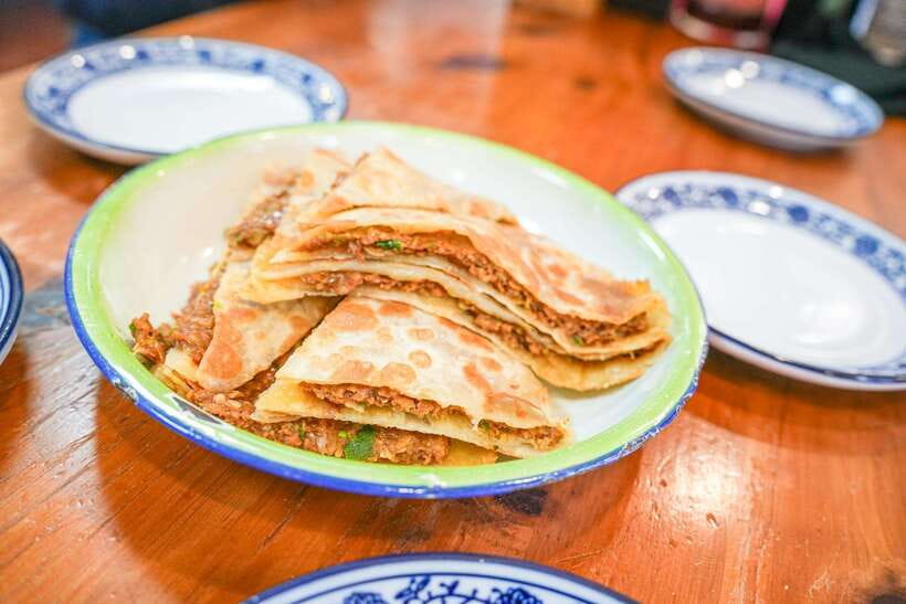 Beijing: Hutong Breakfast Food Tour - Stone doorways, signs, and courtyard clues