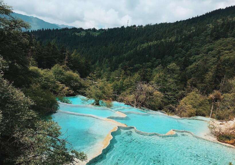 Huanglong Scenic Area: Explore Stunning Five-Colored Ponds - Golden Sand Pavement and the travertine terraces